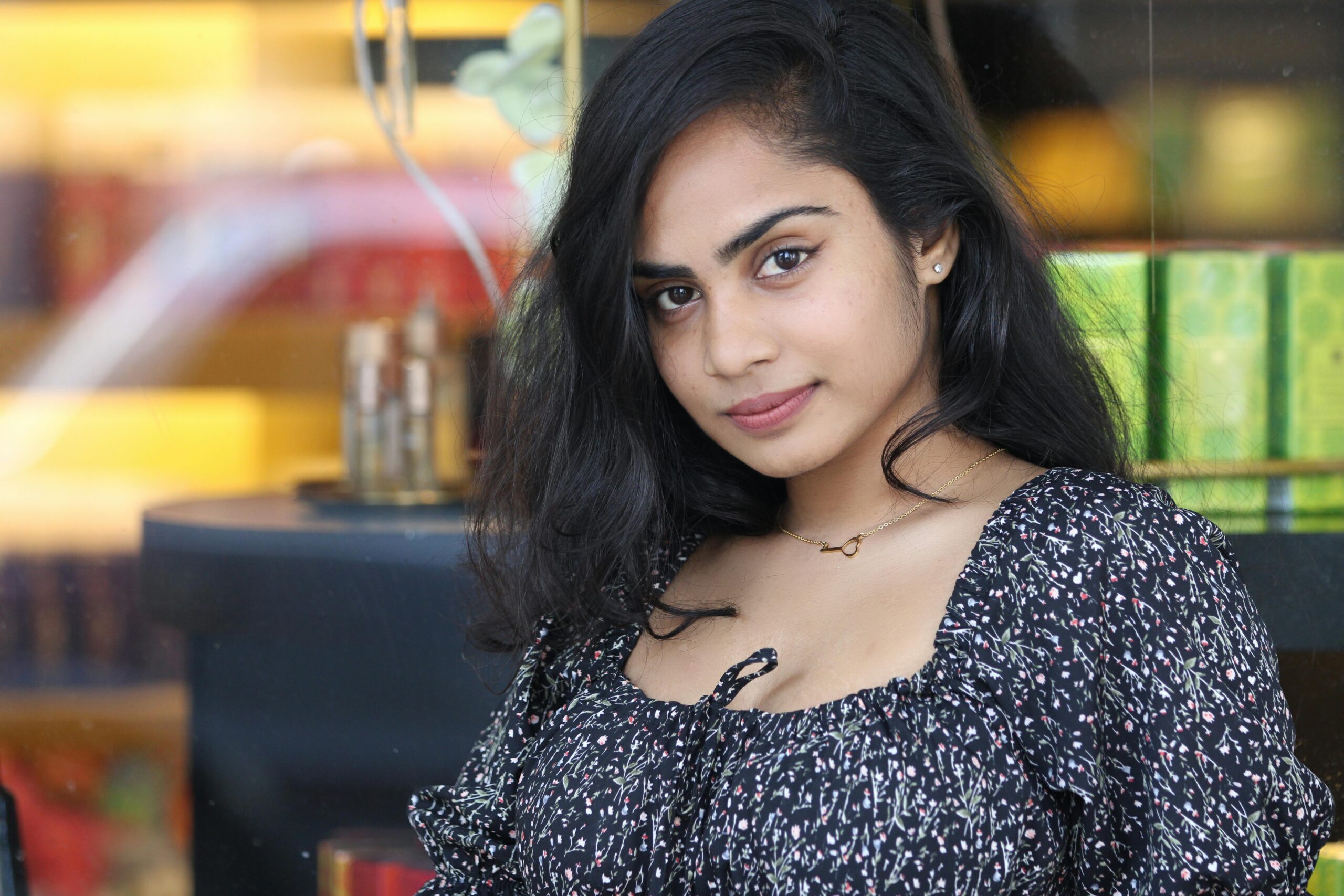 Elegant portrait of a woman with a gentle smile indoors.